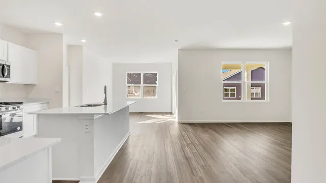 a view of a kitchen with wooden floor and a sink