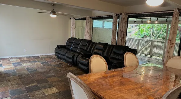 a black leather chair in a room next to a window