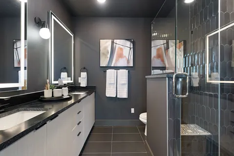 a bathroom with double vanity sinks and a mirror