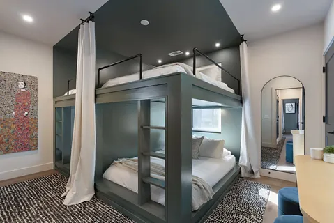 a bathroom with a sink a toilet a mirror and shower