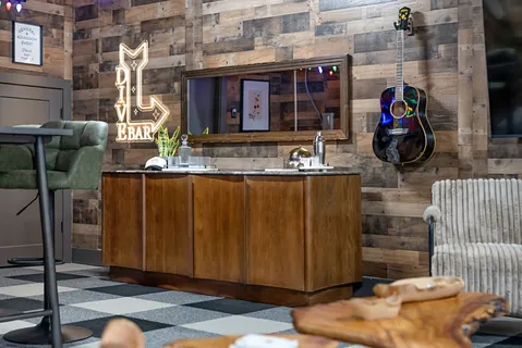 a roof deck with couches and potted plants