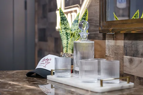 a roof deck with table and chairs with potted plants
