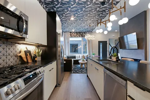 a living room with patio furniture and a potted plant