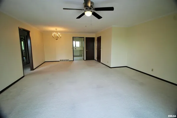 a view of empty room with ceiling fan