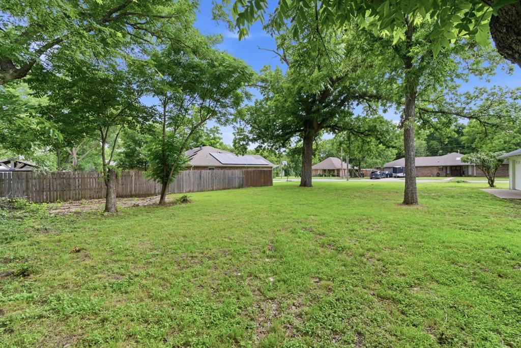 507 Country Club Road Cleburne, TX 76033 - Photo 38 of 39 Expansive green lawn featuring mature trees providing ample shade