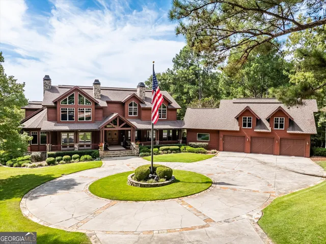 a front view of a house with a yard fountain and garage