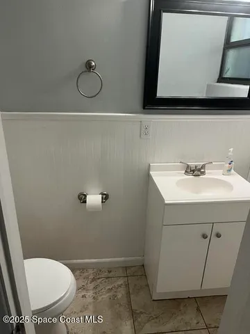 a bathroom with a sink a toilet and mirror