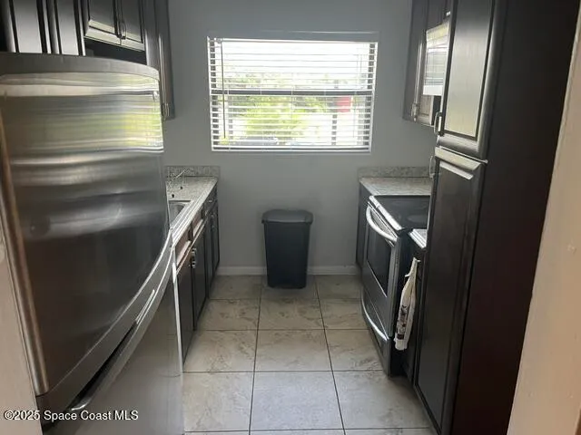 a kitchen with a refrigerator and a stove