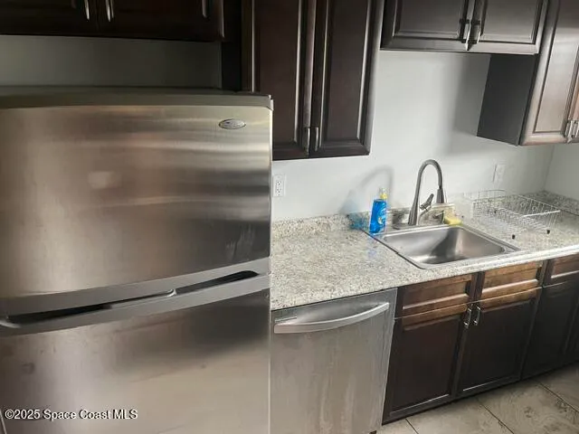 a kitchen with a sink and a refrigerator