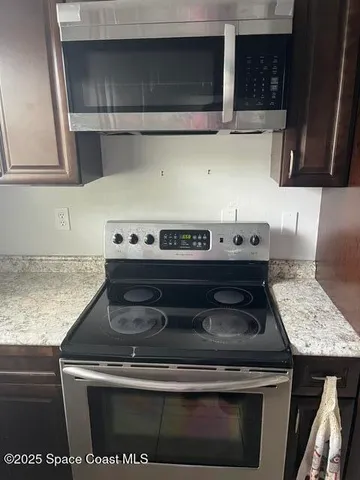 a stove top oven sitting inside of a kitchen