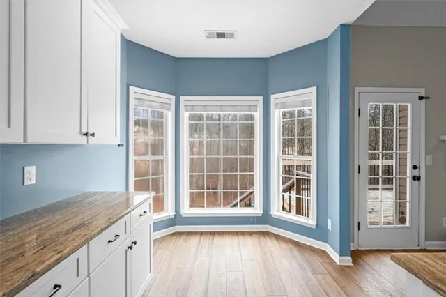 a large kitchen with stainless steel appliances granite countertop a large counter top and a stove top oven