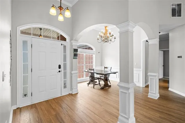 wooden floor fireplace and windows in an empty room