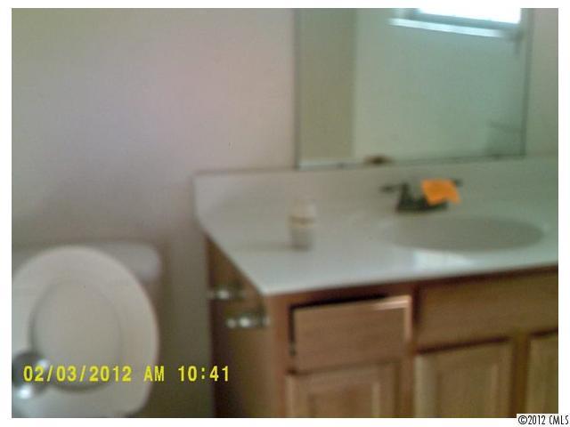 1323 Ben Livingston Road Charlotte, NC 28214 - Photo 5 of 8 a bathroom with a sink and a mirror