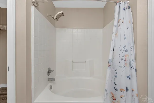 a bathroom with a bathtub and shower