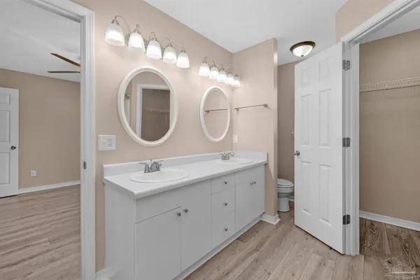 a bathroom with a double vanity sink and a mirror