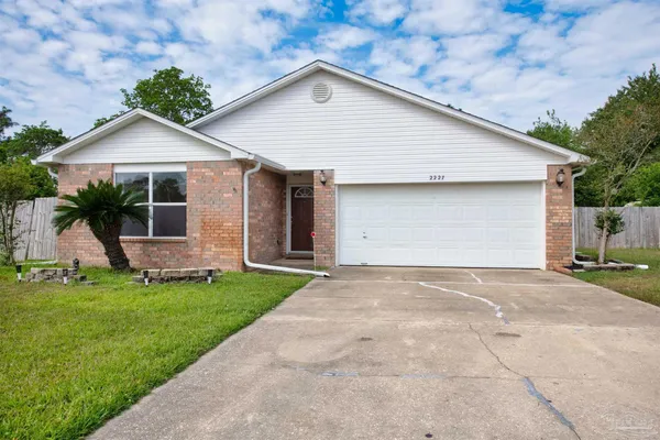 a view of a house with a yard and garage