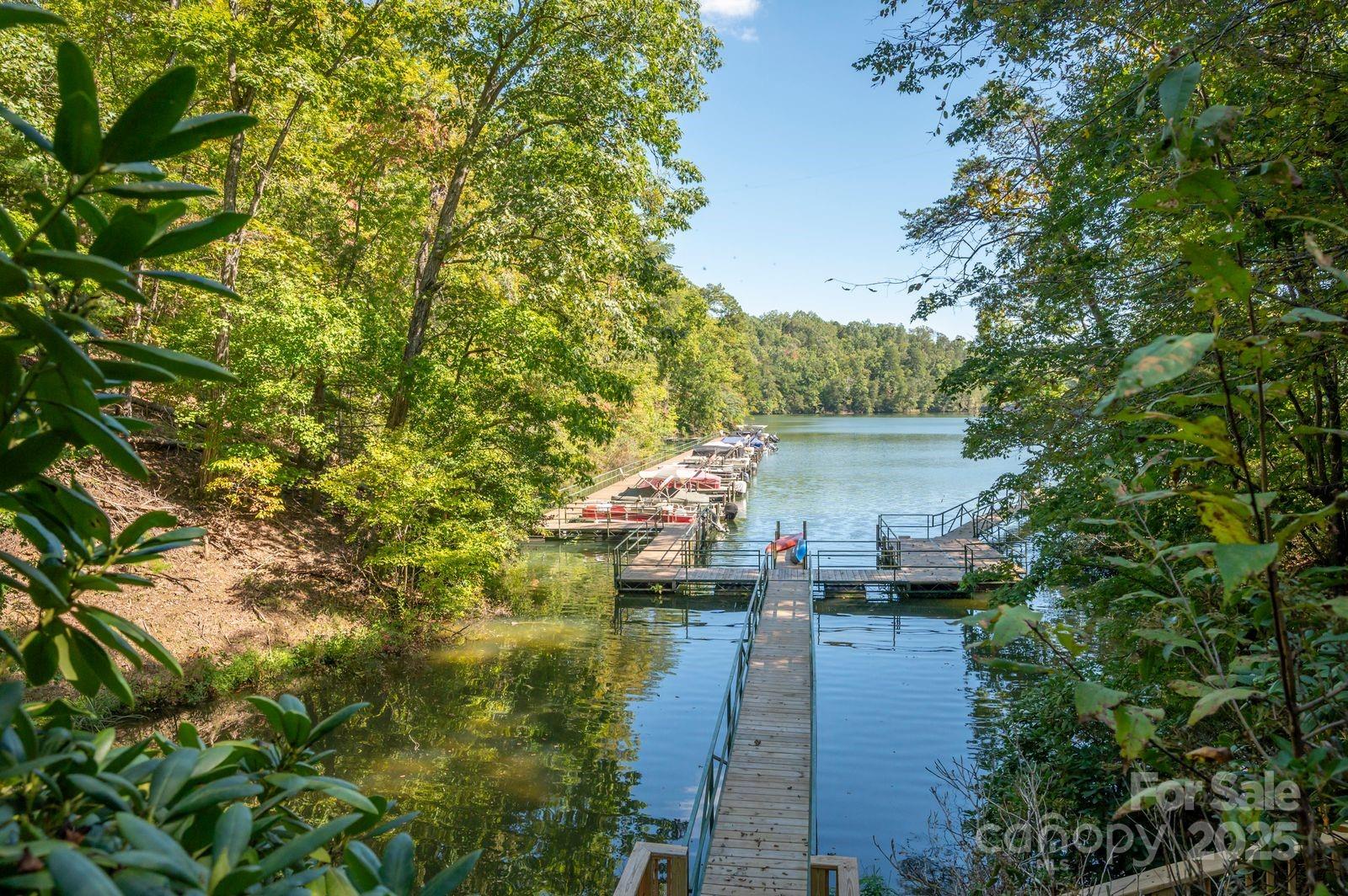 0 Mountain Parkway, Unit 29 Mill Spring, NC 28756 - Photo 15 of 15 a view of a lake with a building in the background