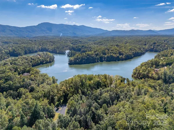 a wooden bench sitting in the middle of a yard