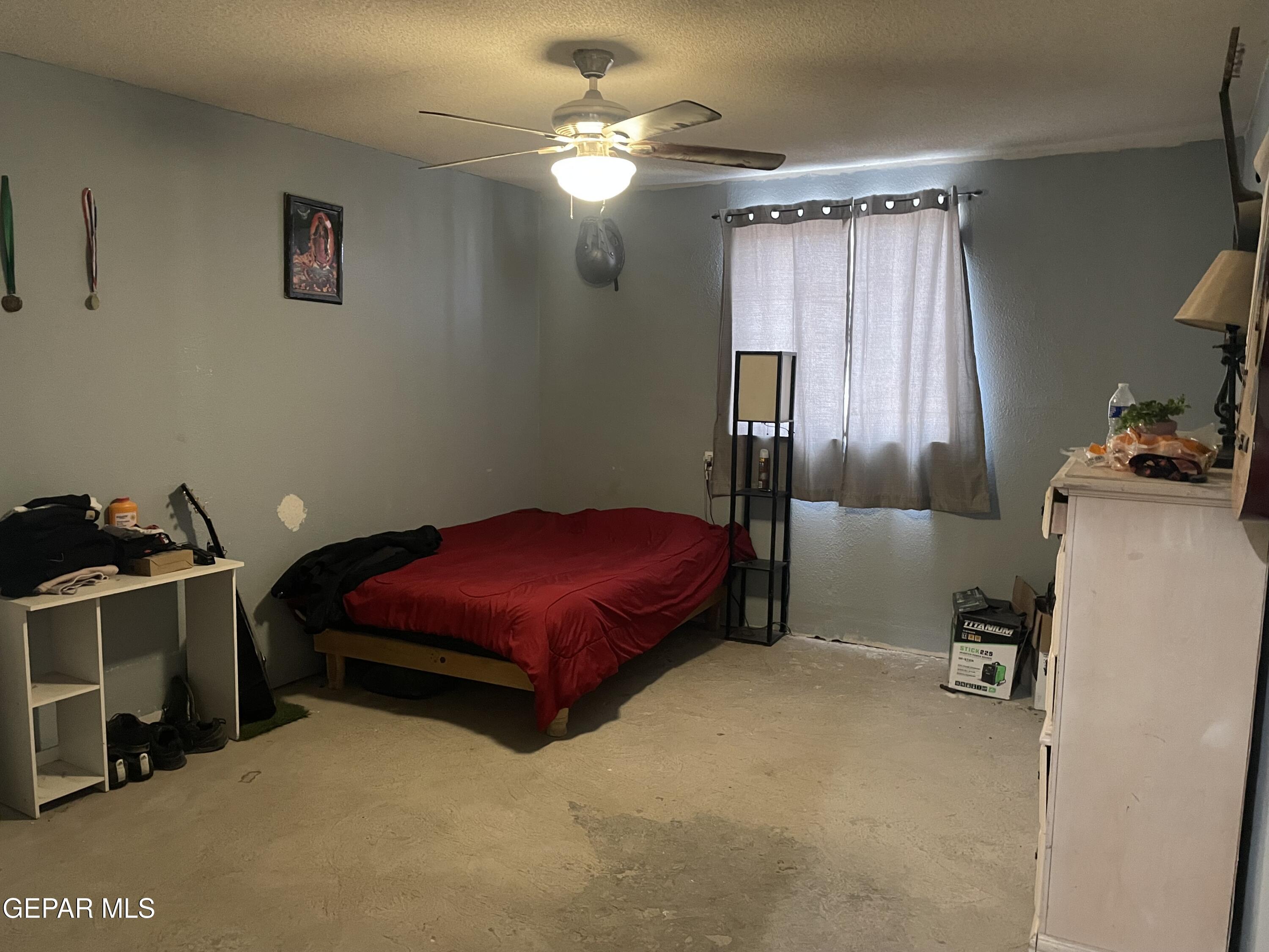 966 Traymore Road El Paso, TX 79928 - Photo 11 of 27 a bedroom with a bed and a chandelier