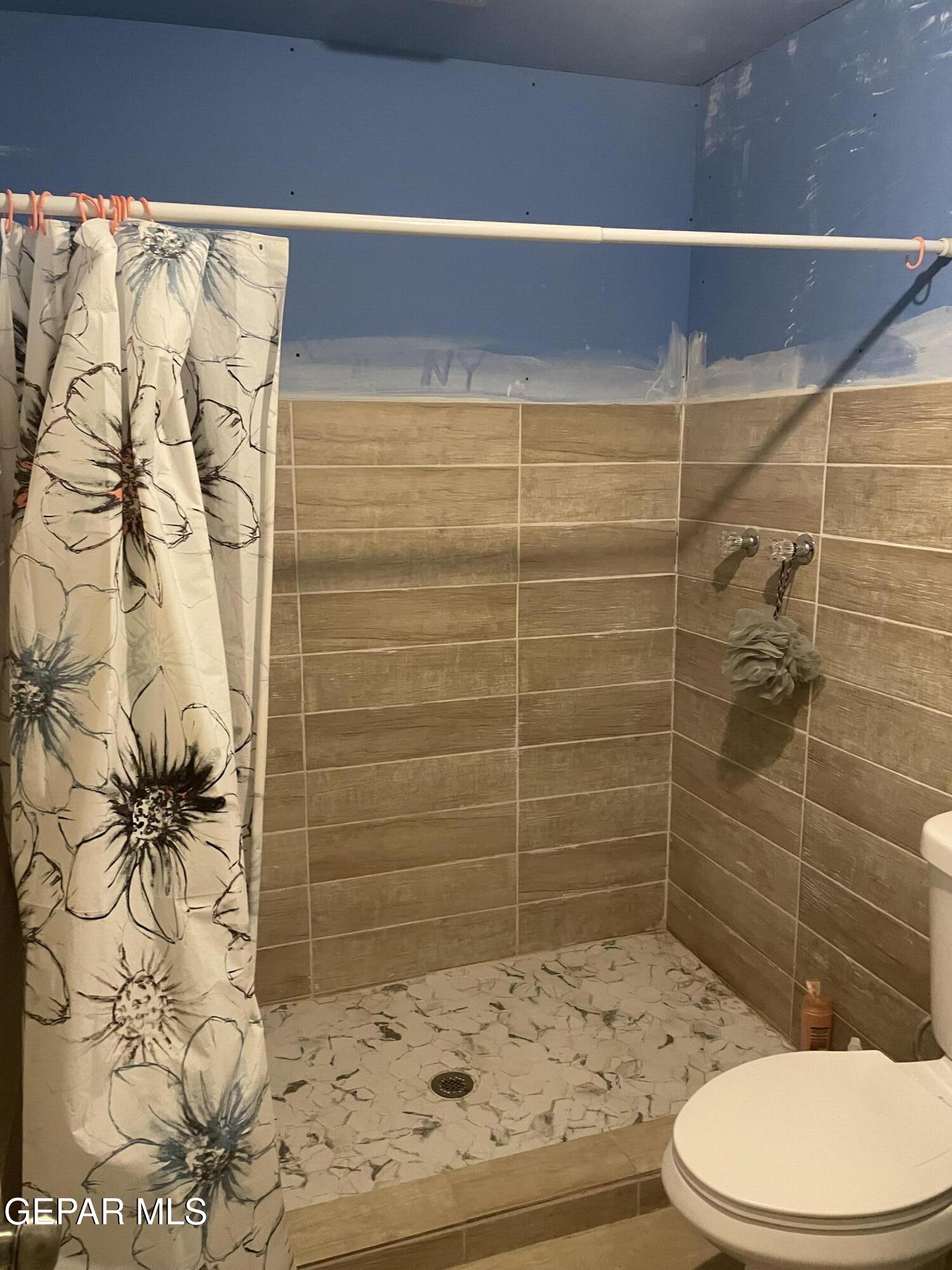 966 Traymore Road El Paso, TX 79928 - Photo 12 of 27 a bathroom with a toilet and shower