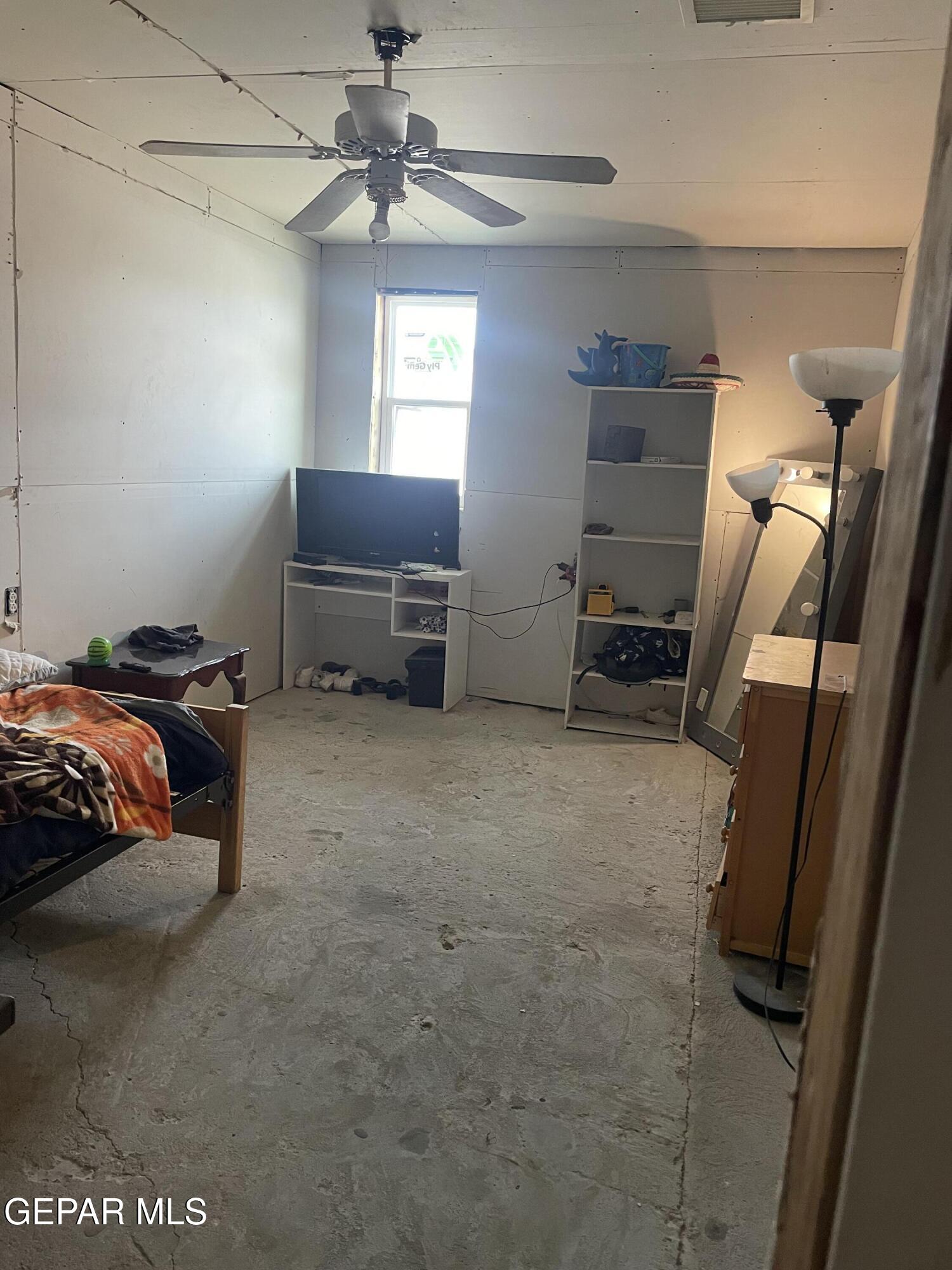 966 Traymore Road El Paso, TX 79928 - Photo 14 of 27 a bedroom with a bed and a tv