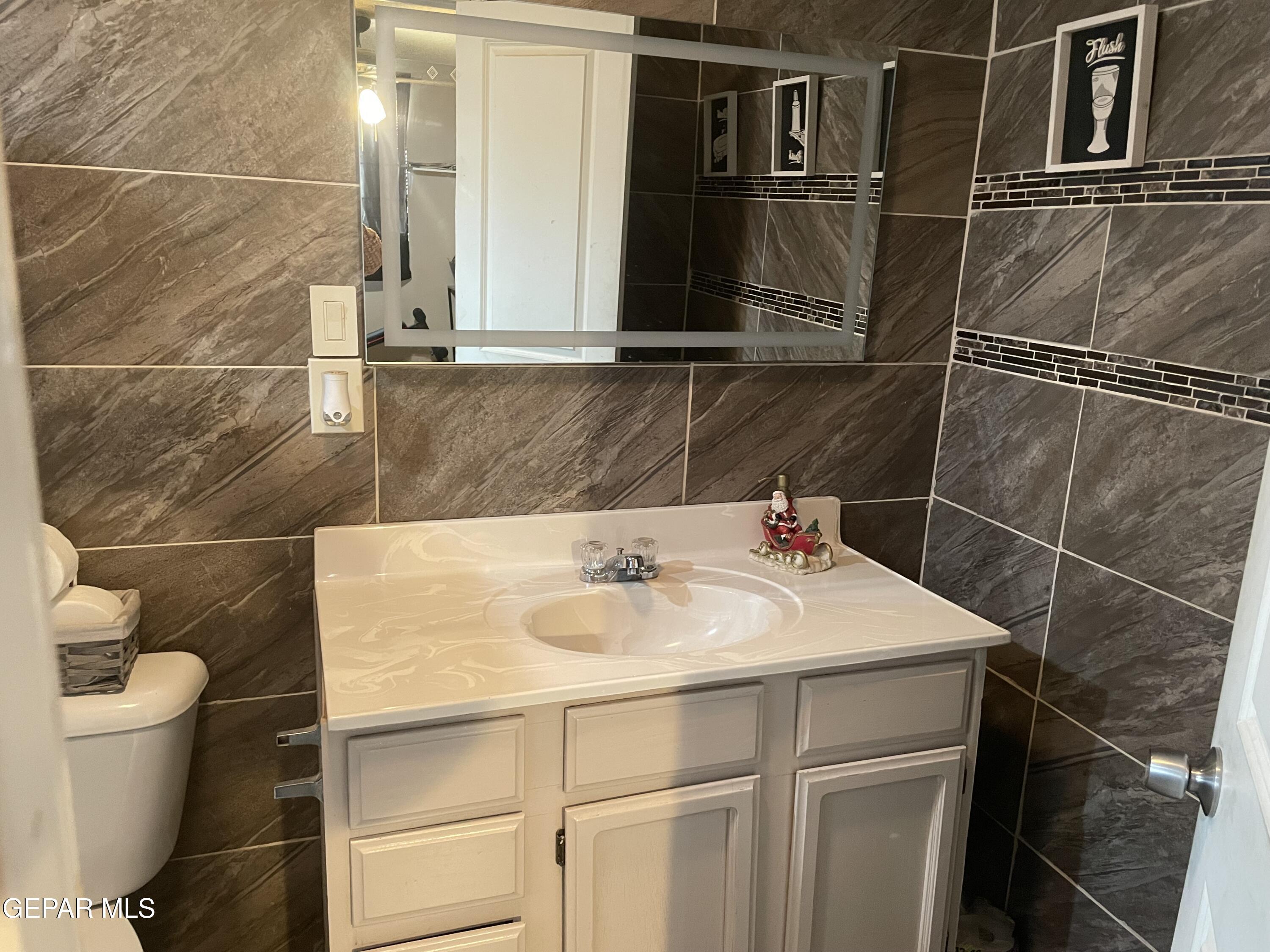 966 Traymore Road El Paso, TX 79928 - Photo 18 of 27 a bathroom with a sink and a toilet