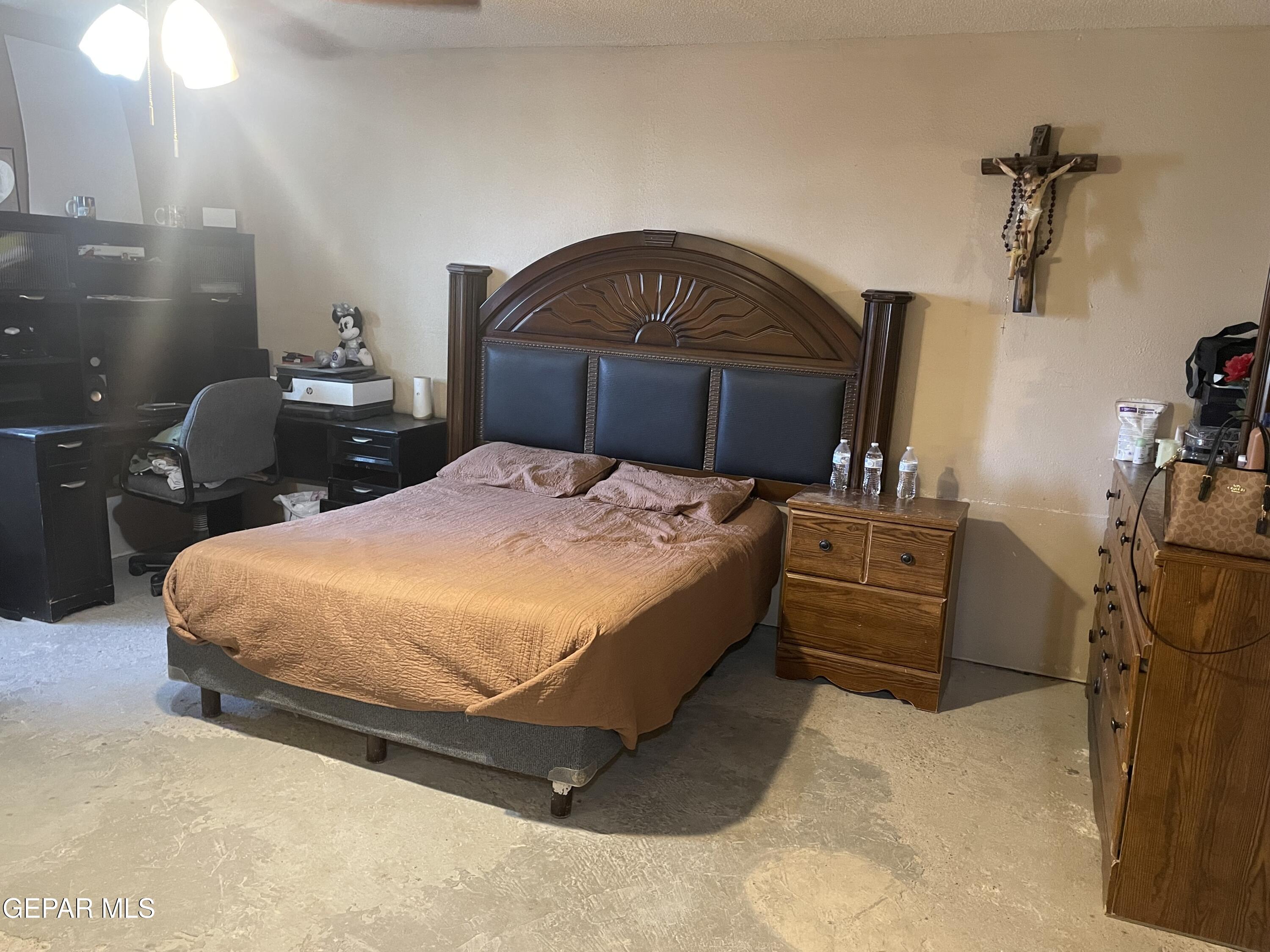 966 Traymore Road El Paso, TX 79928 - Photo 19 of 27 a bedroom with a bed and a lamp on dresser