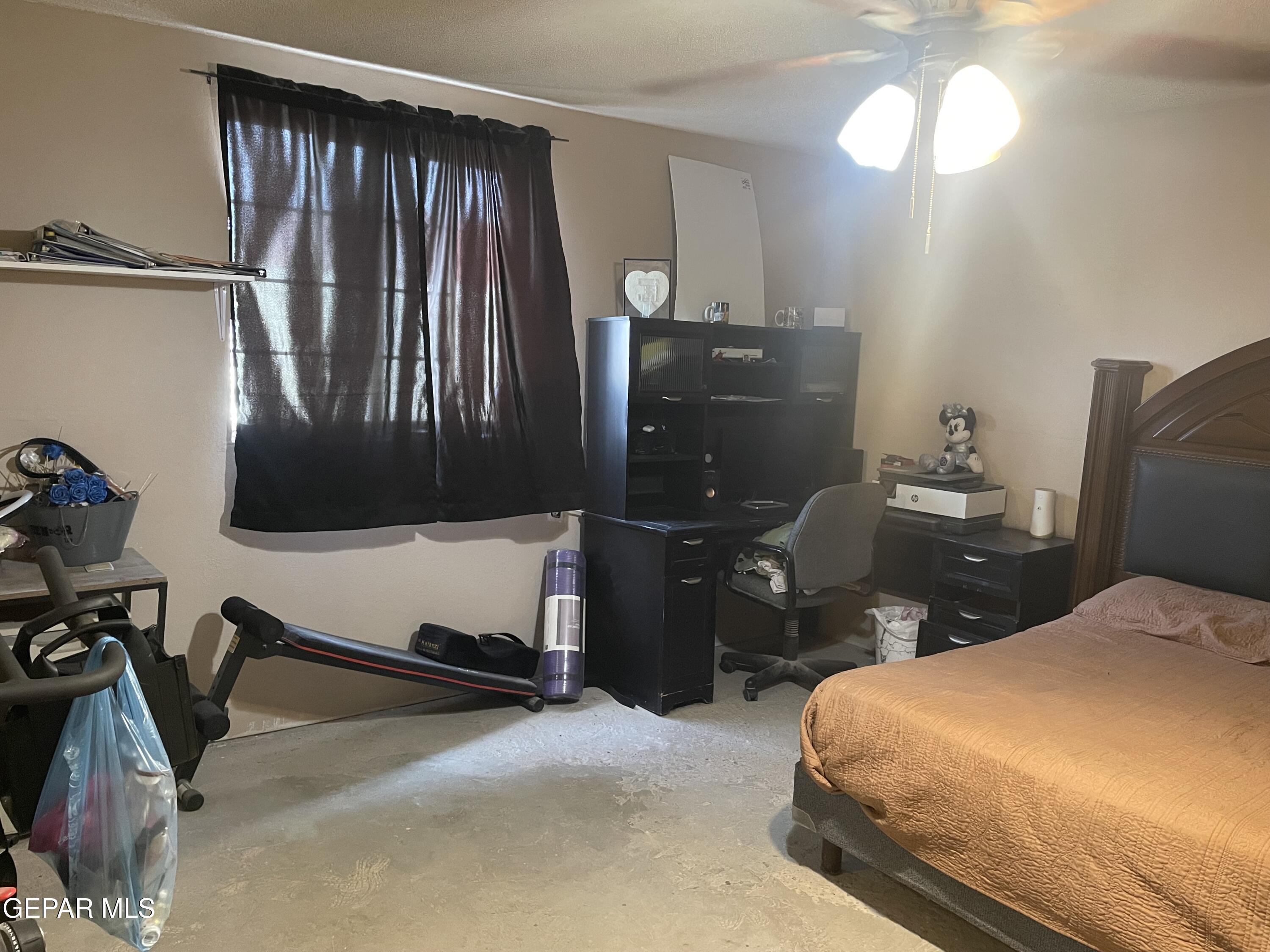 966 Traymore Road El Paso, TX 79928 - Photo 21 of 27 a bedroom with a bed and a chandelier