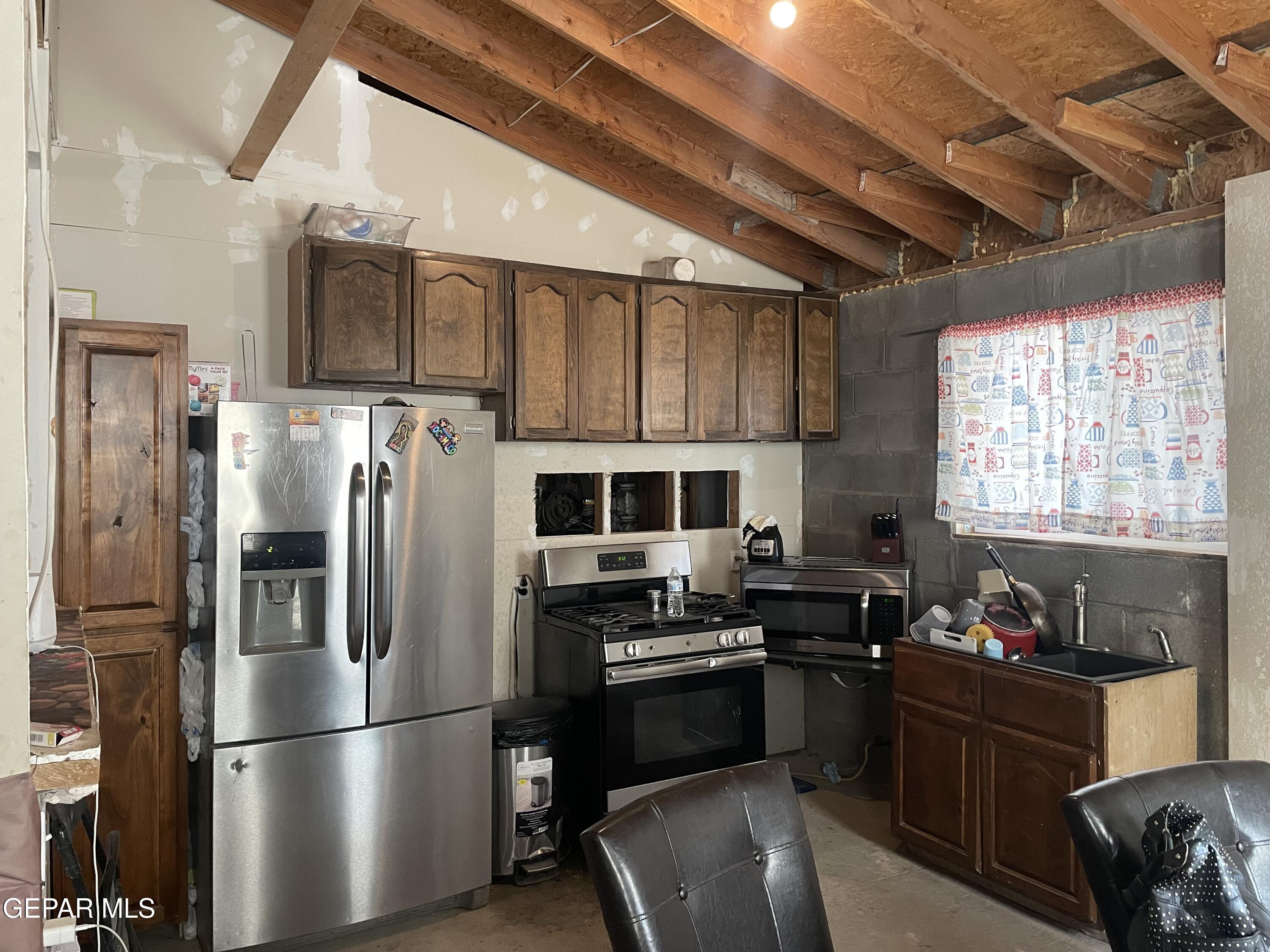 966 Traymore Road El Paso, TX 79928 - Photo 8 of 27 a kitchen with stainless steel appliances granite countertop a refrigerator and a stove top oven