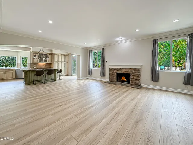 an empty room with furniture fireplace and wooden floor