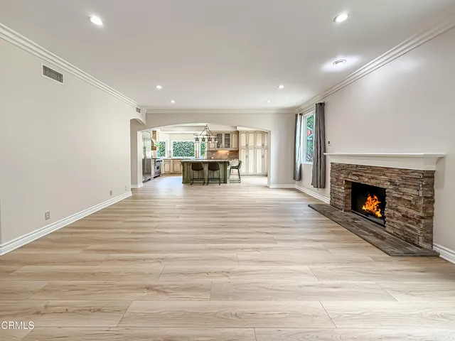 a view of livingroom with kitchen and fireplace