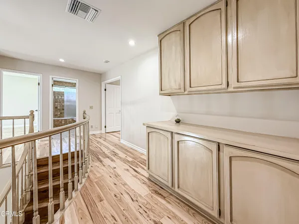 a view of a kitchen with wooden floor and cabinets