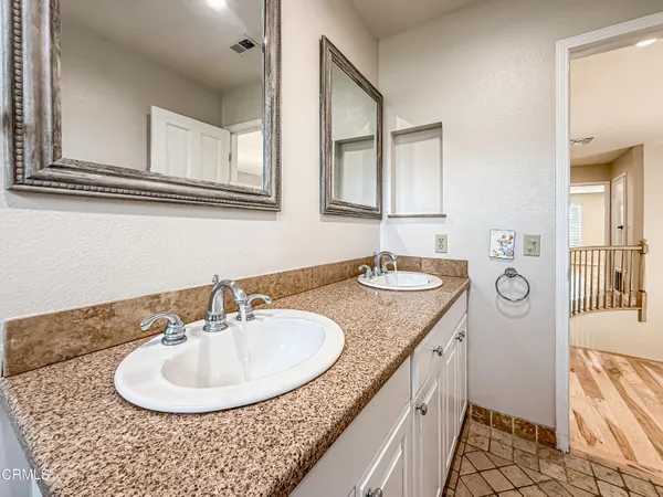 a bathroom with a granite countertop sink a mirror and a