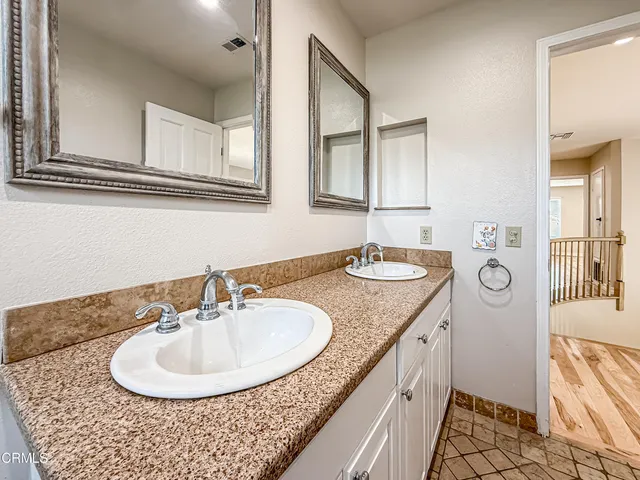 a bathroom with a granite countertop sink a mirror and a