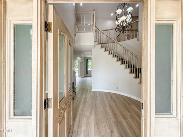 a view of entryway and hall with wooden floor