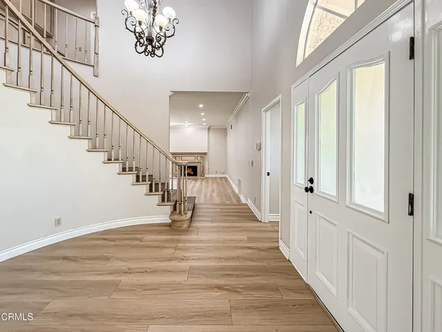 a view of entryway and hall with wooden floor