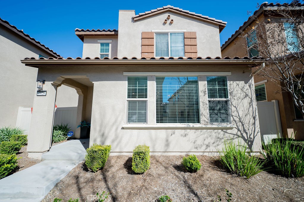 1928 Ray Abril Jr Lane Colton, CA 92324 - Photo 1 of 33 a front view of a house with potted plants