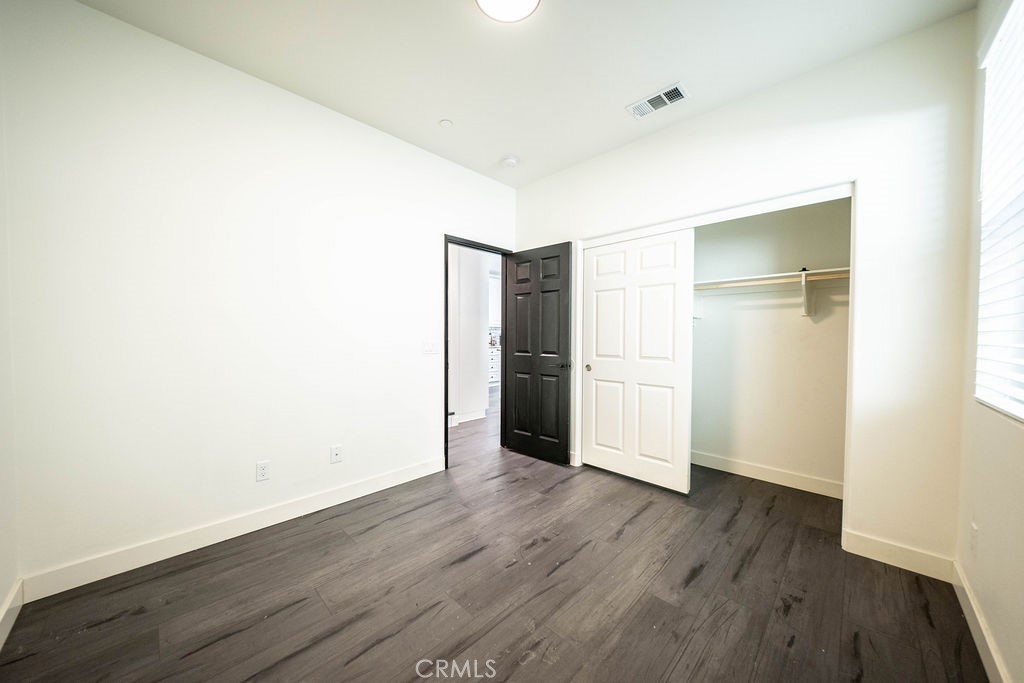 1928 Ray Abril Jr Lane Colton, CA 92324 - Photo 15 of 33 a view of an empty room with wooden floor