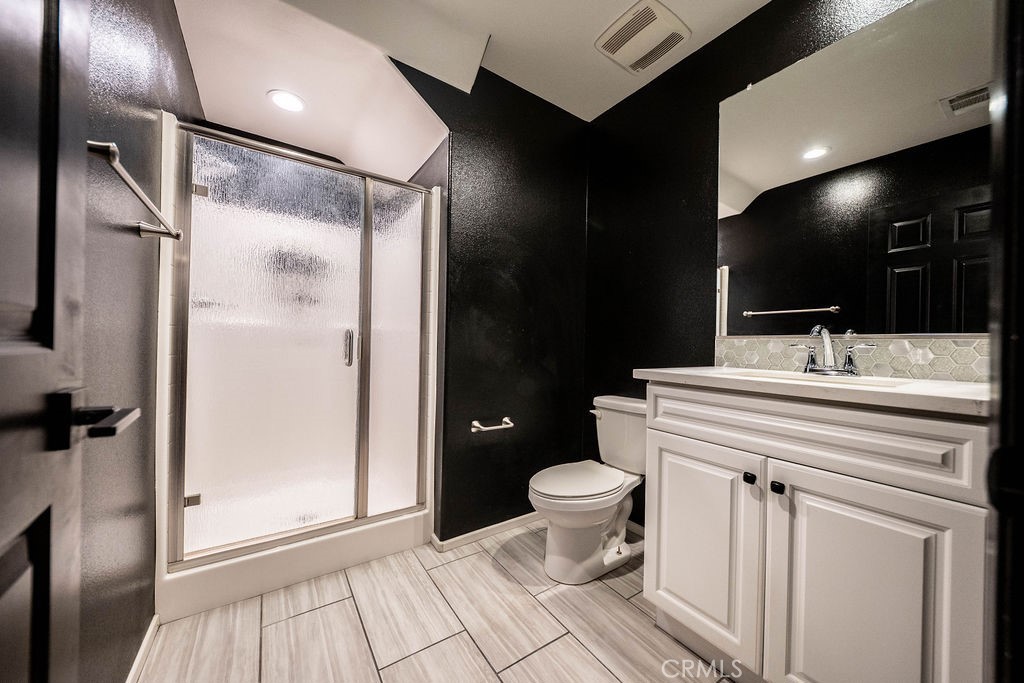 1928 Ray Abril Jr Lane Colton, CA 92324 - Photo 16 of 33 a bathroom with a sink toilet and shower