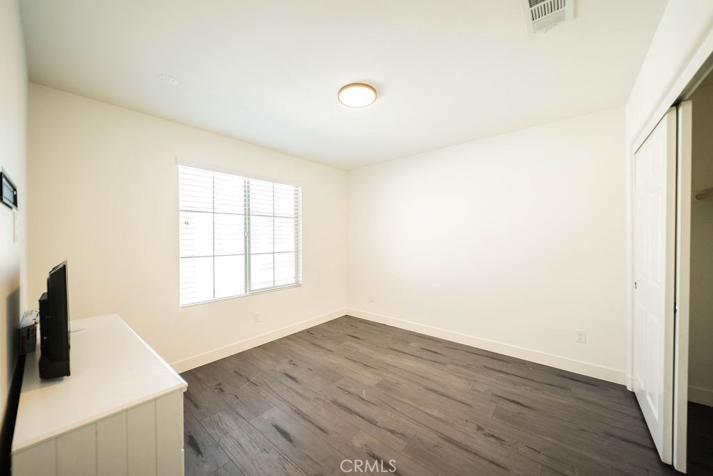 1928 Ray Abril Jr Lane Colton, CA 92324 - Photo 19 of 33 a view of a kitchen with wooden floor and white walls