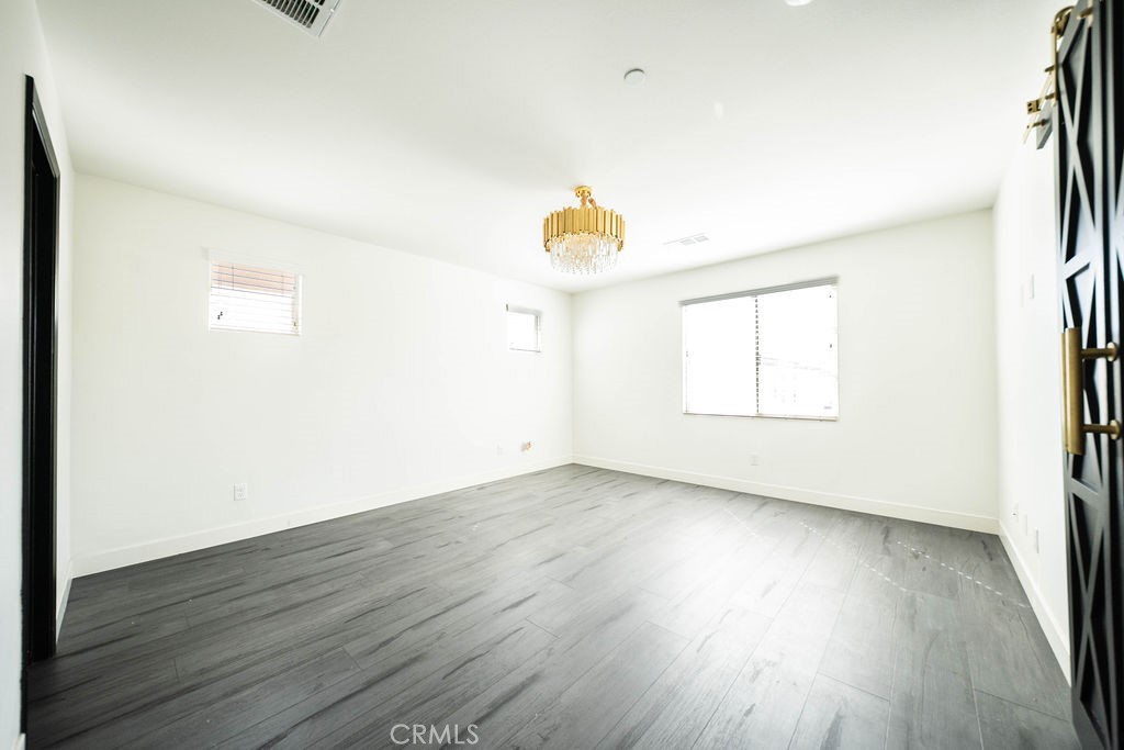 1928 Ray Abril Jr Lane Colton, CA 92324 - Photo 25 of 33 a view of empty room with wooden floor and fan