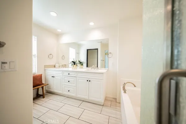 a spacious bathroom with a double vanity sink and a mirror