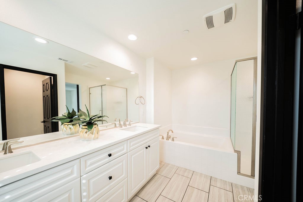 1928 Ray Abril Jr Lane Colton, CA 92324 - Photo 32 of 33 a bathroom with a double vanity sink mirror and bathtub