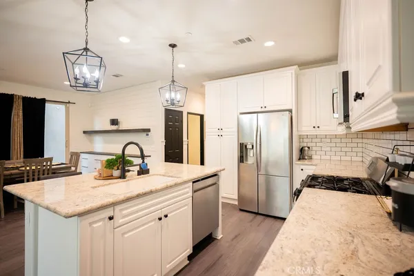 a kitchen with a refrigerator a sink and a stove