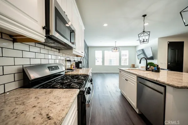 a kitchen with a stove a sink and a refrigerator
