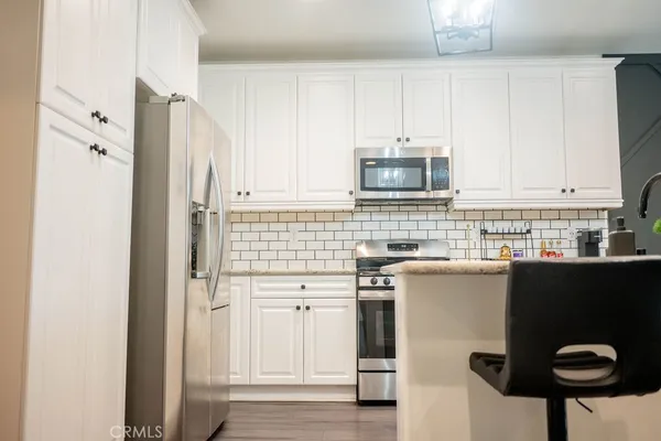 a kitchen with a cabinets and appliances
