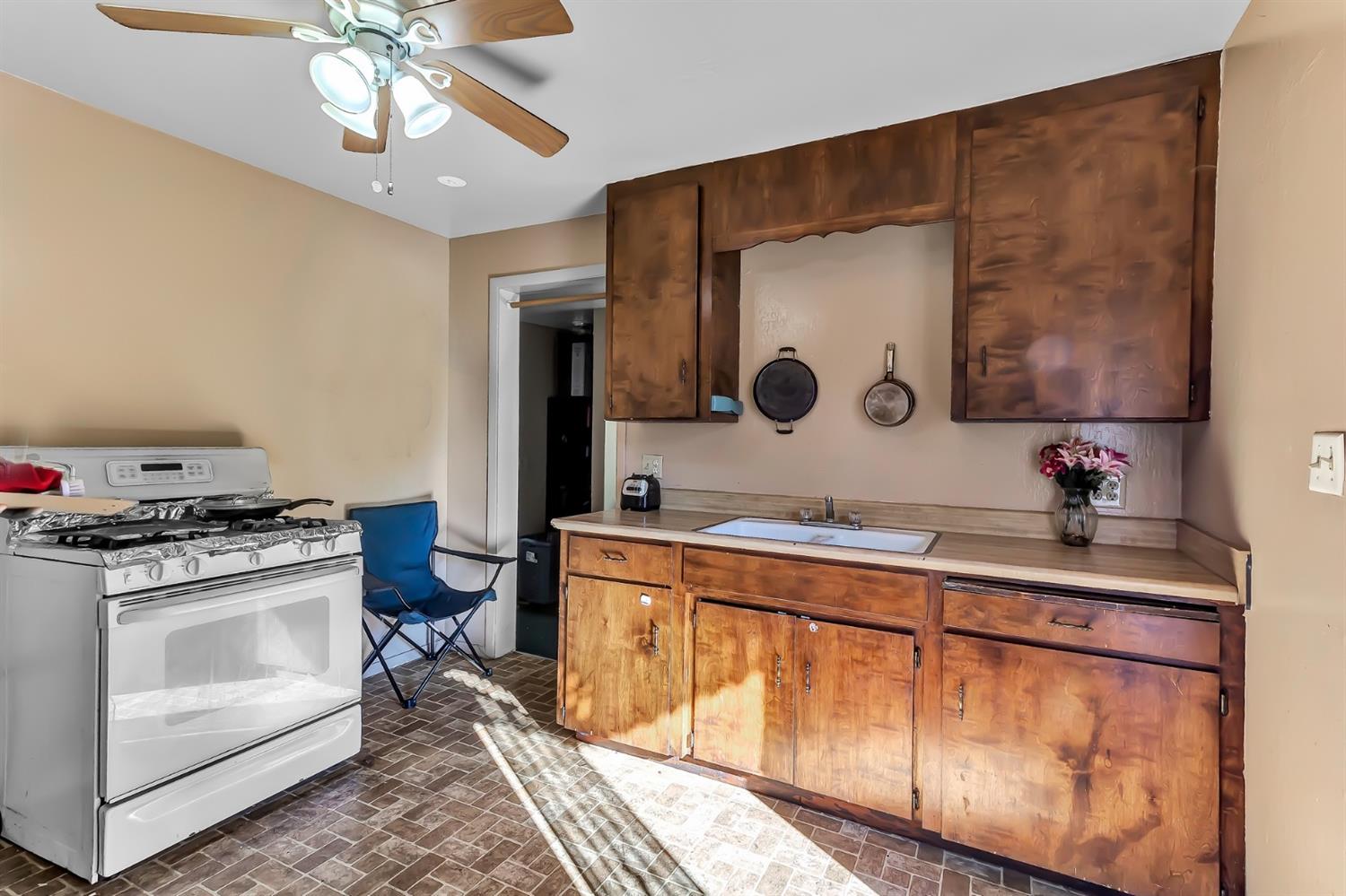 320 Acacia Street Lodi, CA 95240 - Photo 17 of 31 a kitchen with a stove and a sink