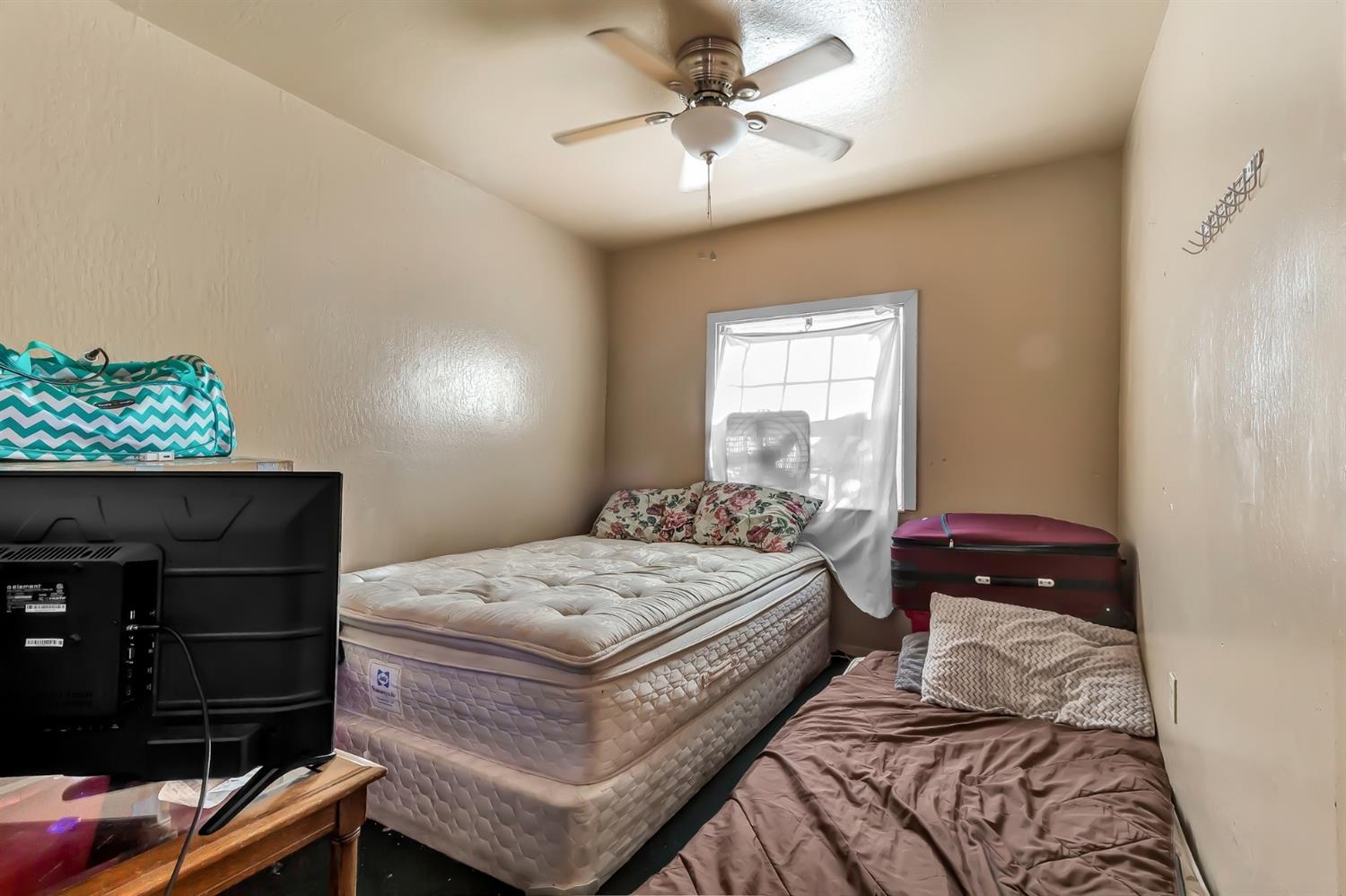 320 Acacia Street Lodi, CA 95240 - Photo 20 of 31 a bedroom with a bed and a window