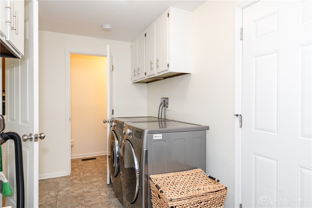 728 Chipplegate Drive Centerville, OH 45459 - Photo 14 of 30 This dedicated laundry room features modern appliances and ample storage for a highly functional space.