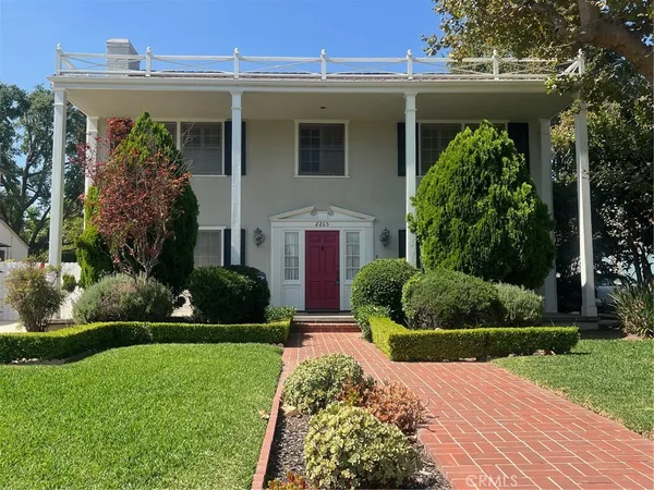 a front view of a house with garden